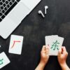 Flat lay mockup for online courses of Chinese language. Laptop and cards with basic printed