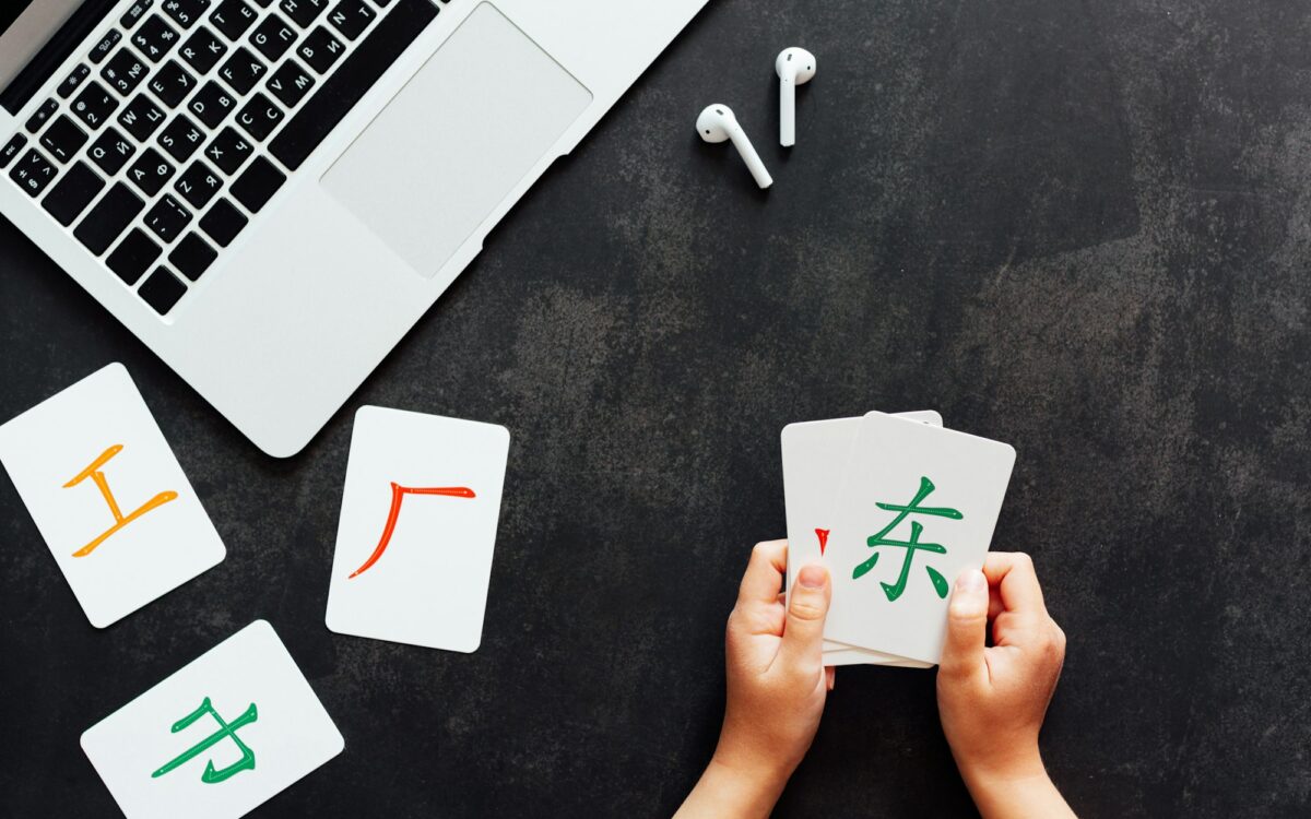 Flat lay mockup for online courses of Chinese language. Laptop and cards with basic printed